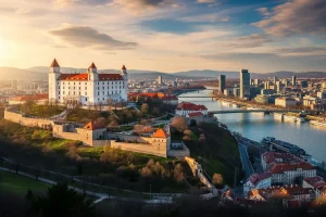 A photo of Bratislava Castle on a hill, overlooking the city with the Danube River