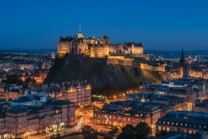 A photo of Edinburgh Castle perched on a hill, with the city below.