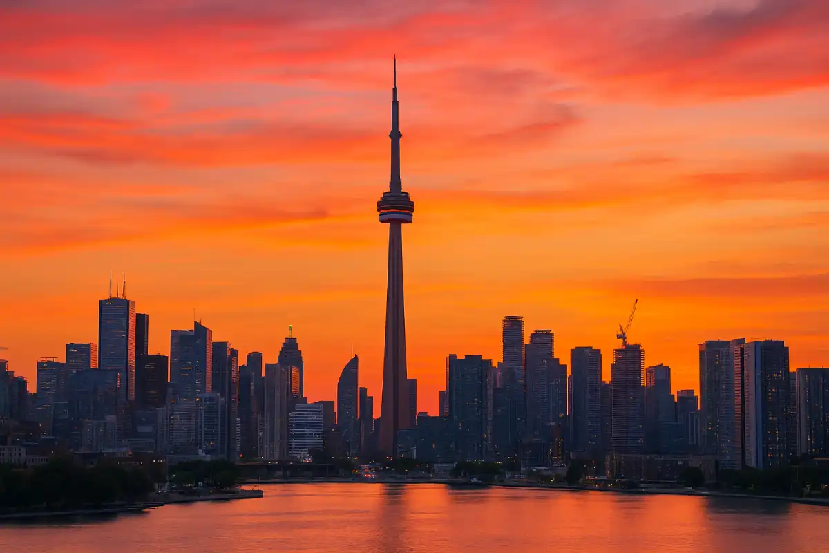 A photo of the Toronto skyline at sunset, with the CN Tower prominent.