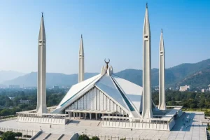 The massive, modern white marble structure of the Faisal Mosque in Islamabad.