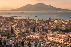 A panoramic view of Naples with the historic buildings and Mount Vesuvius in the background.