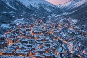 Andorra la Vella's dense city centre nestled in the valley, surrounded by the snowy peaks of the Pyrenees mountains.