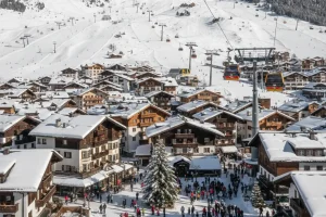 The dense village of Ischgl with the ski slopes and high-altitude lift systems visible in the background.