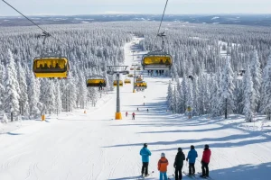 Wide, perfectly groomed ski slopes on Mount Trysil, Norway, with modern lifts and a dense pine forest.