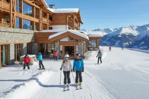 A luxurious mountain hotel nestled directly against a wide, groomed ski run with guests stepping immediately out of the hotel lobby and onto the snow with their skis on, capturing the dream of true slope-side convenience.