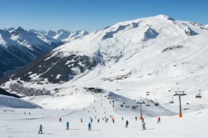 A panoramic view of the vast, high-altitude glacier and ski slopes of Les Deux Alpes, with clear blue skies.