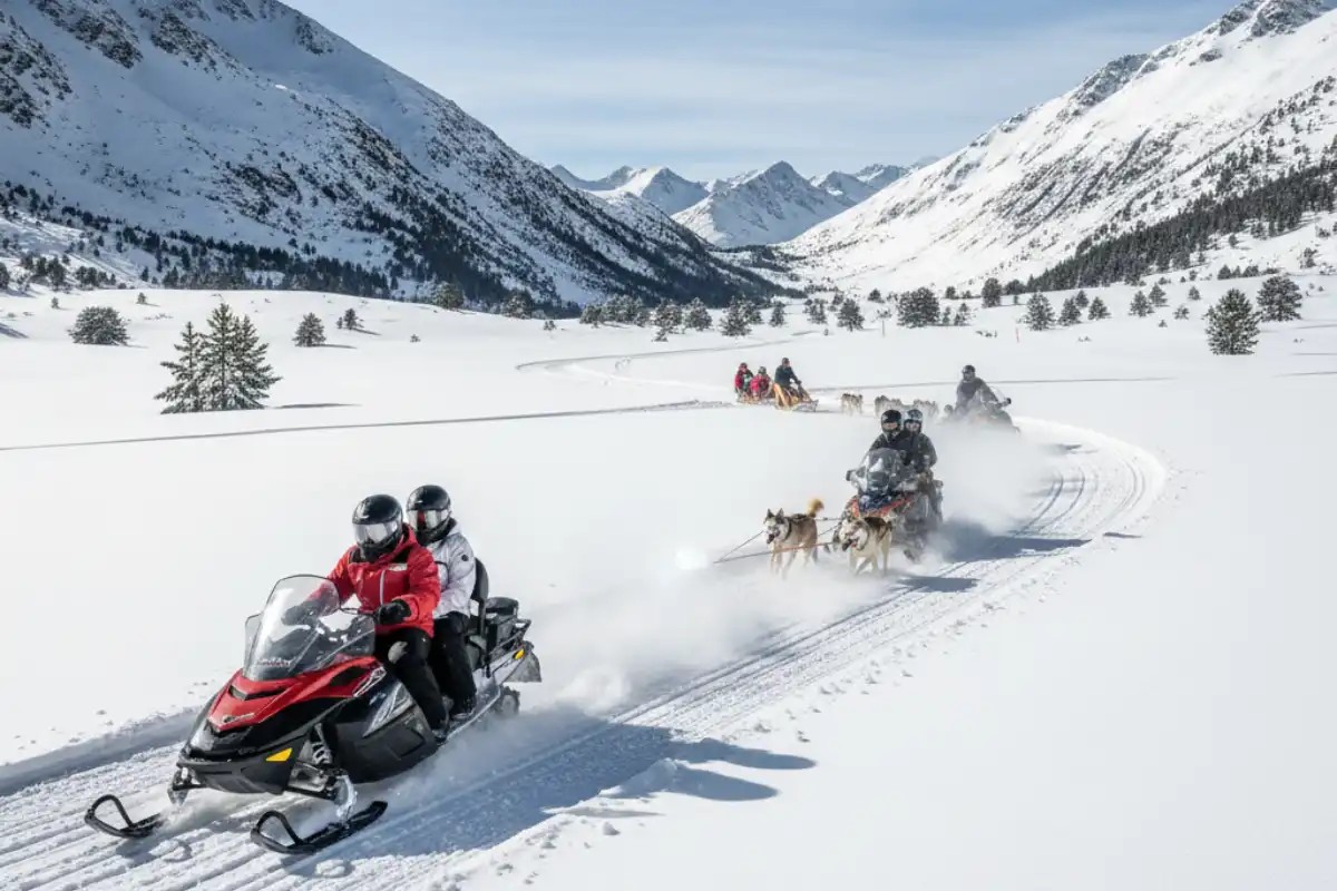 People enjoying snowmobiling and dog sledding activities on the snow in the Grau Roig sector of Grandvalira.