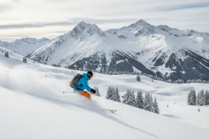 A skier making turns in deep, fresh powder snow in the off-piste terrain surrounding the slopes of St. Anton am Arlberg.