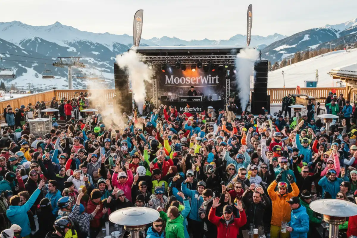 A huge, vibrant crowd of skiers enjoying dancing and drinks at the outdoor terrace of the legendary MooserWirt après-ski bar near the slopes of St. Anton.