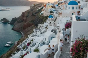 The iconic white-washed architecture of Oia perched on volcanic cliffs overlooking the Aegean Sea