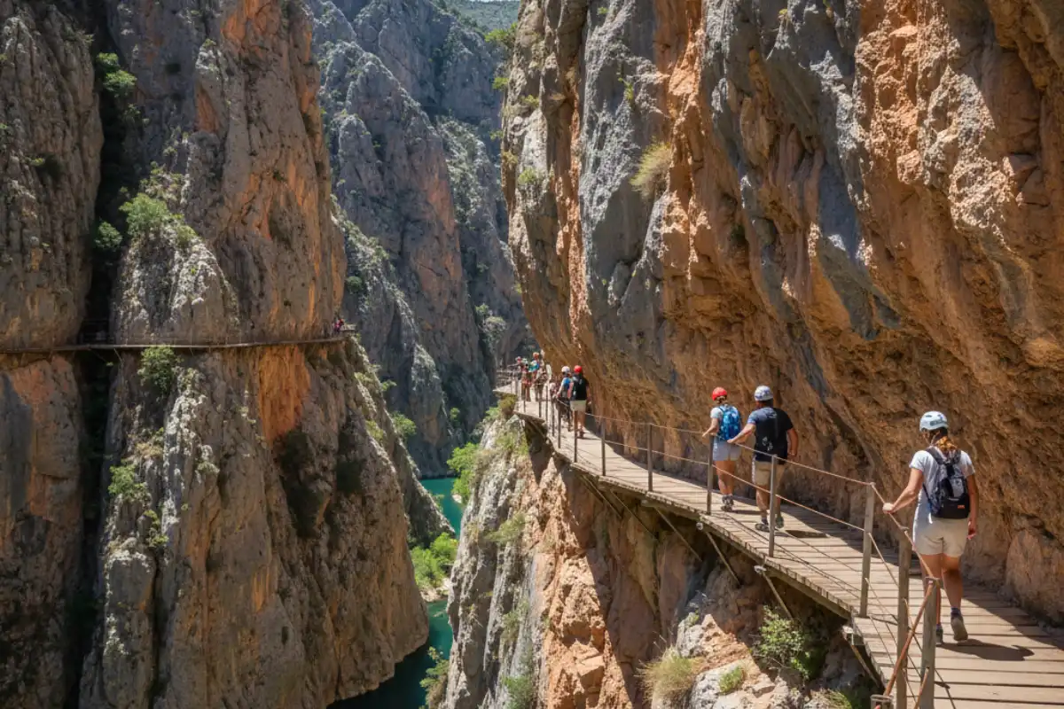 The narrow wooden walkway of Caminito del Rey pinned to the vertical walls of the Gaitanes Gorge