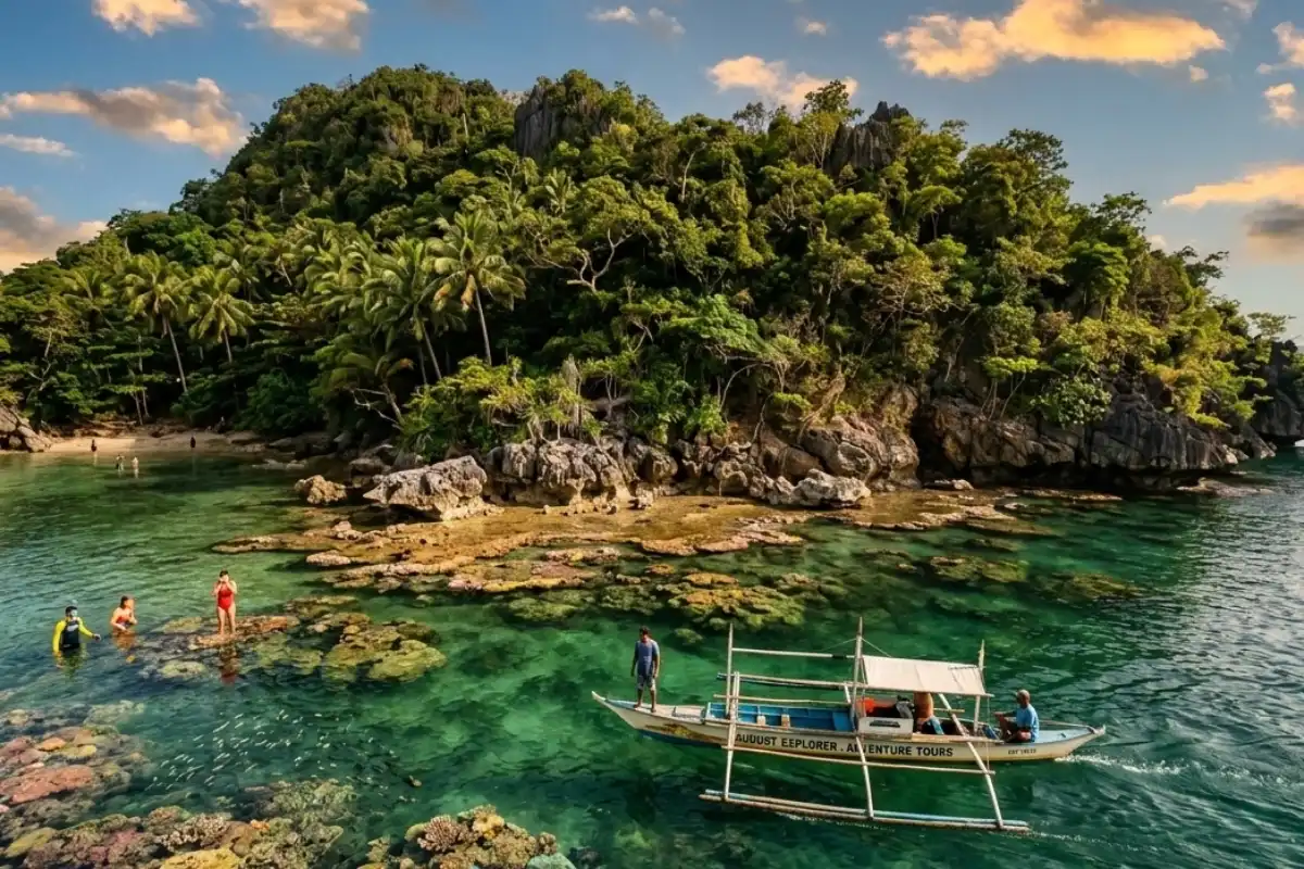 A small boat approaching a lush green tropical island with clear emerald water and colorful snorkeling spots along the rocky shore